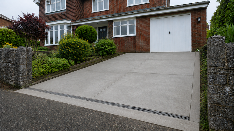Finished concrete driveway at red-brick home